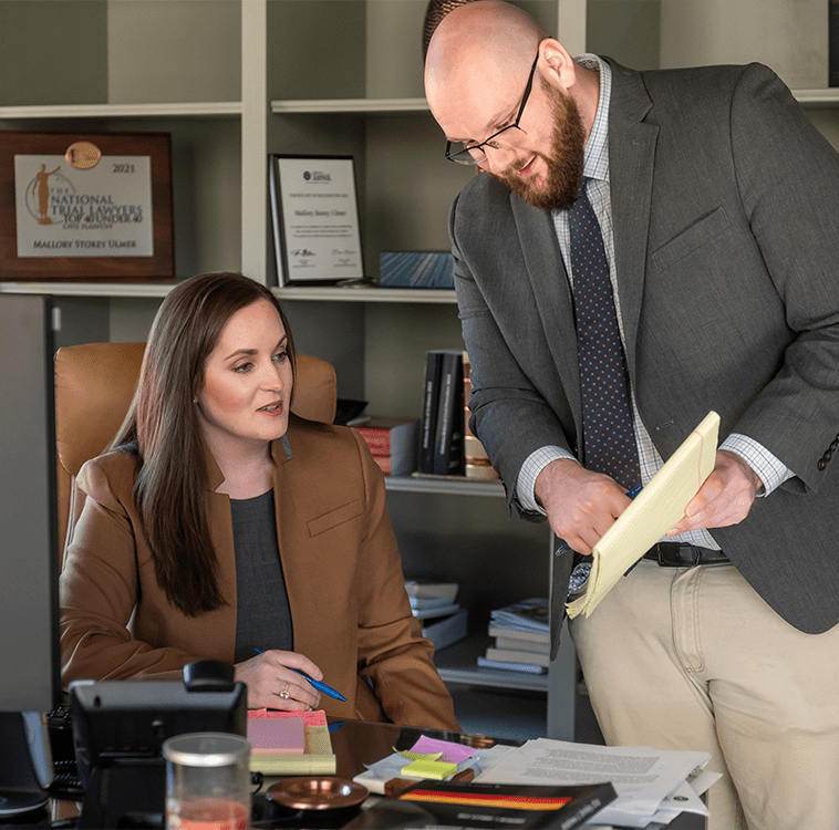 Attorney Mallory Storey Ulmer and her A Team discussing a personal injury case.